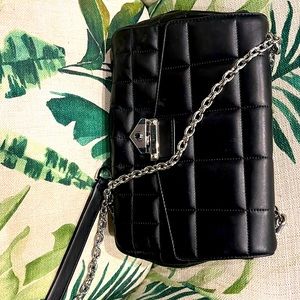A Michael Kors quilted black purse with silver chain
